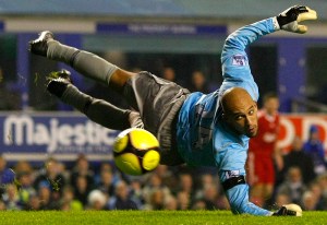Everton's Howard dives for the ball during their FA Cup fourth round replay soccer match against Liverpool in Liverpool