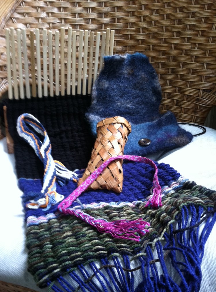 This is what I made at Traditional Ways! Still under construction: peg weaving scarf. Finished: random strip of cloth I made via fingerweaving. Bracelet made doing tablet weaving. Cedar bark teeny basket/pouch I will use for eyeglasses. Felted wool pouch.